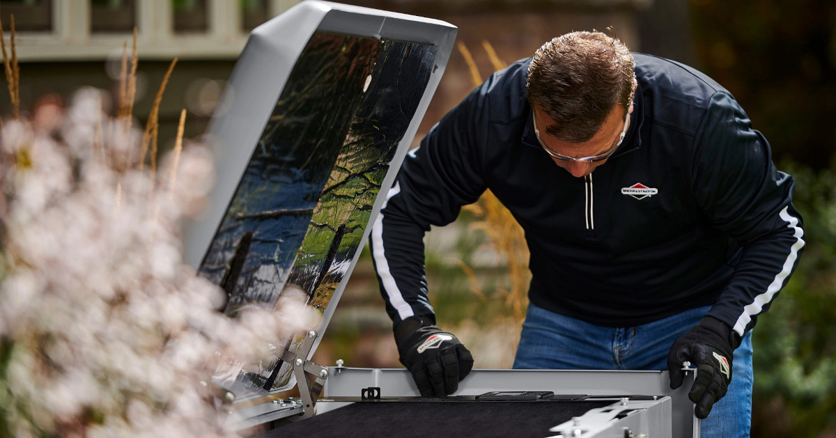 An installer technician shows homeowners their new Briggs and Stratton standby generator.